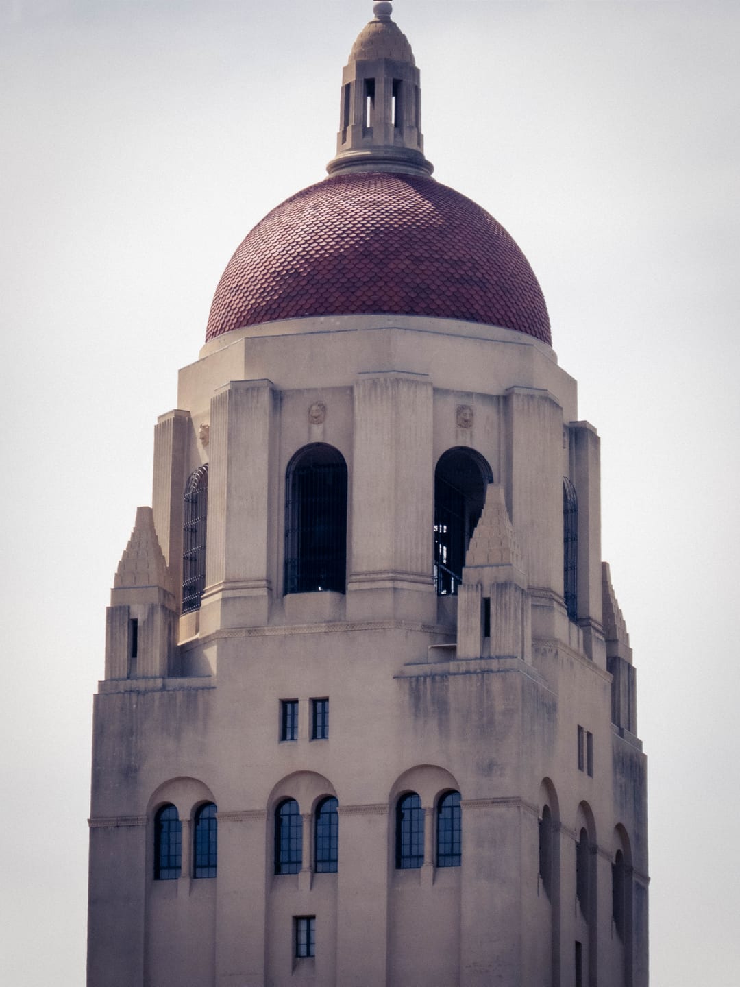top of hoover tower at stanford against a white sky, red tiled dome